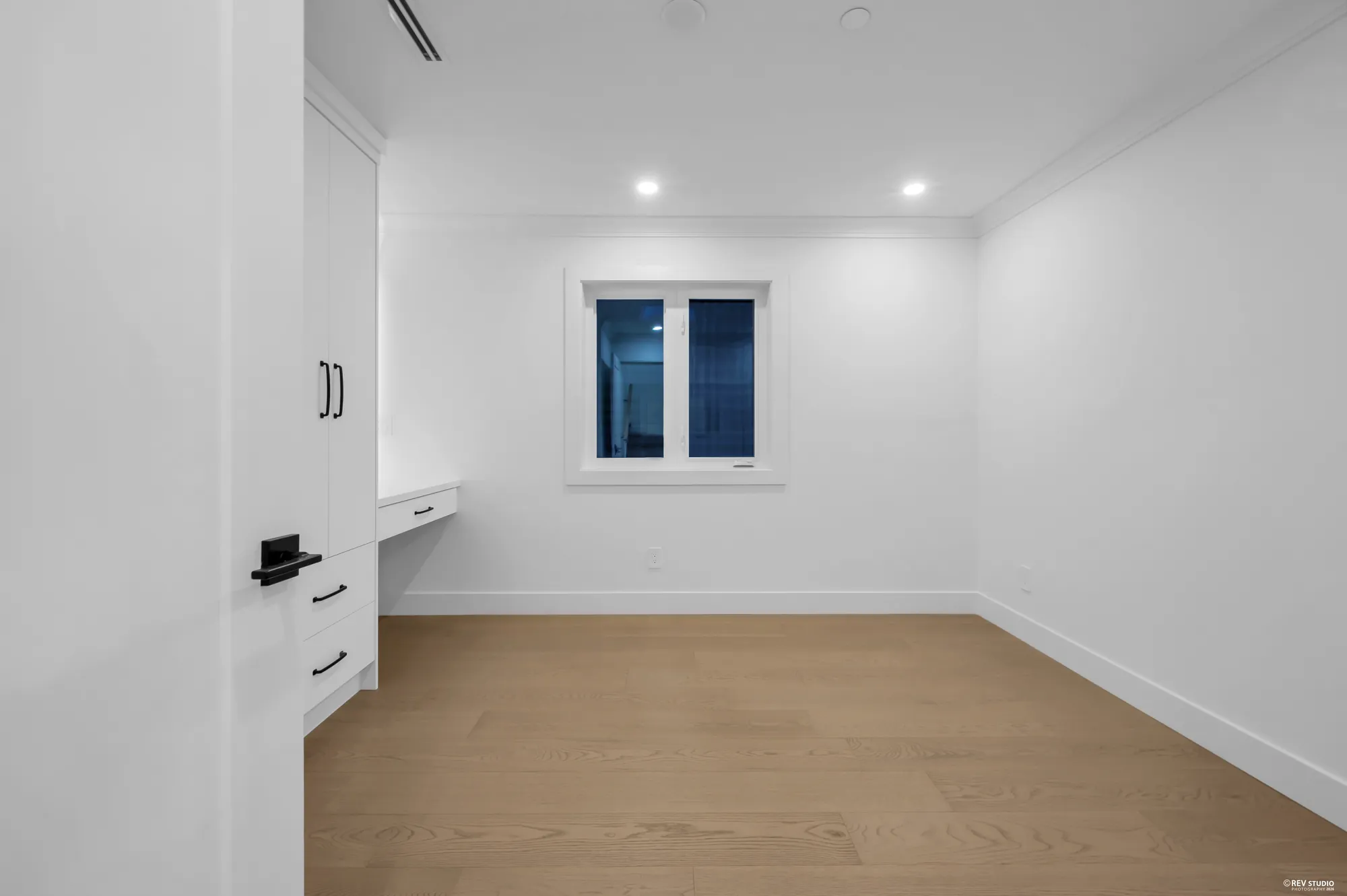 The other bedroom on this floor with a window and a built-in desk