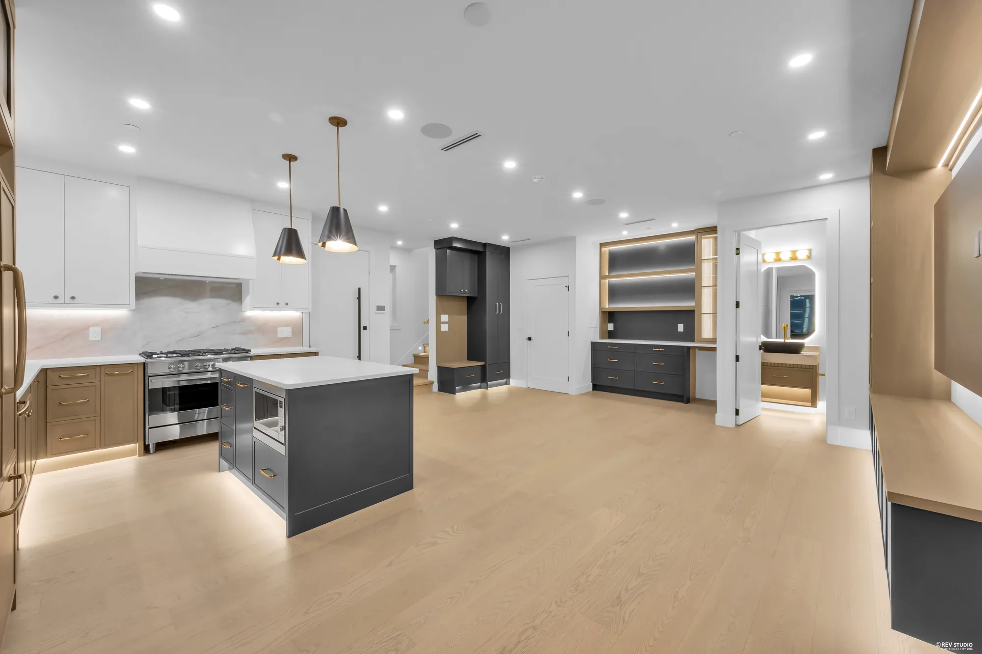 The range, hood and full-height cabinetry behind