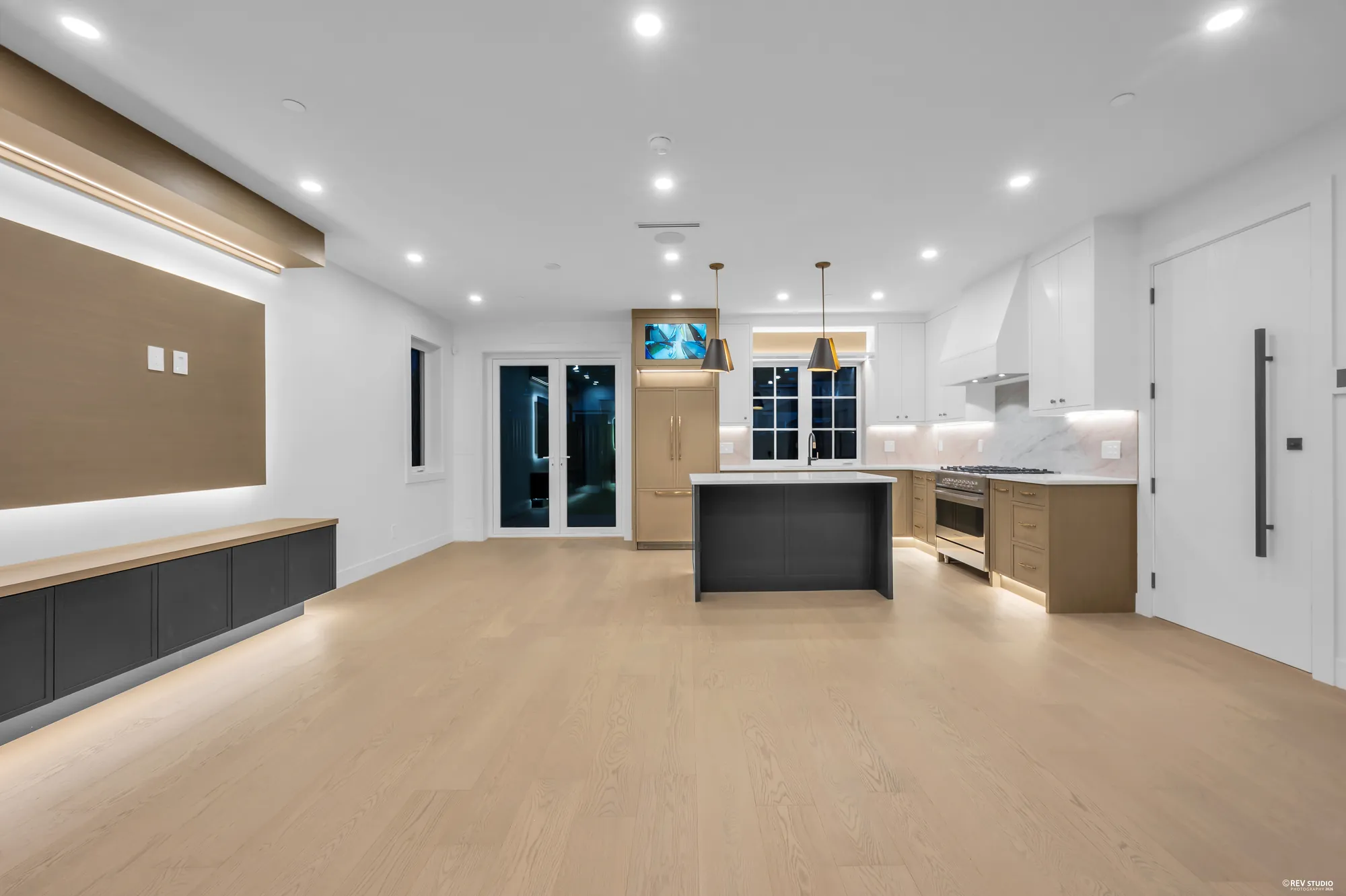 Long main-floor room with the kitchen island at the far end