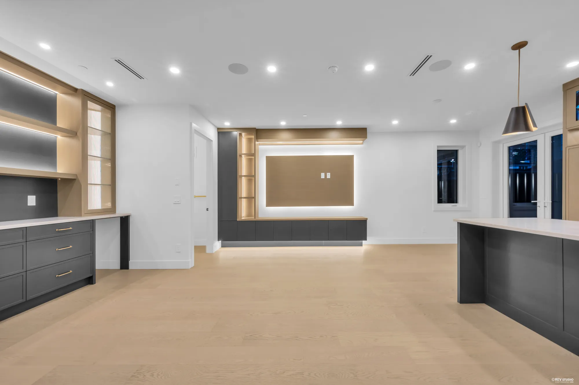 The built-in wall with a backlit recess and the kitchen beyond