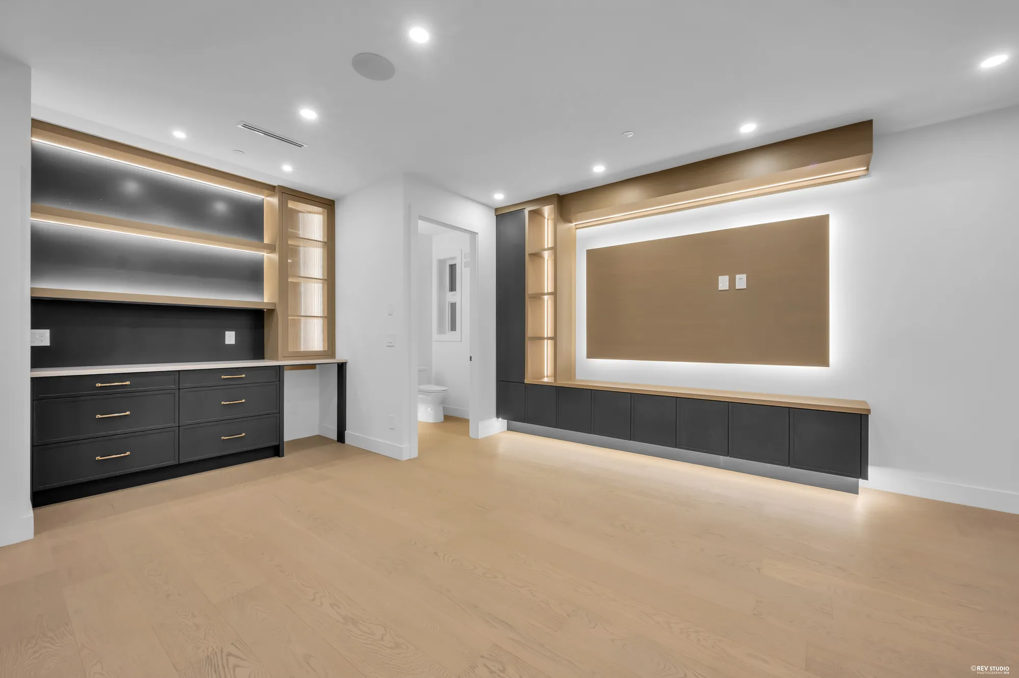 Living area with cabinetry either side of the fireplace