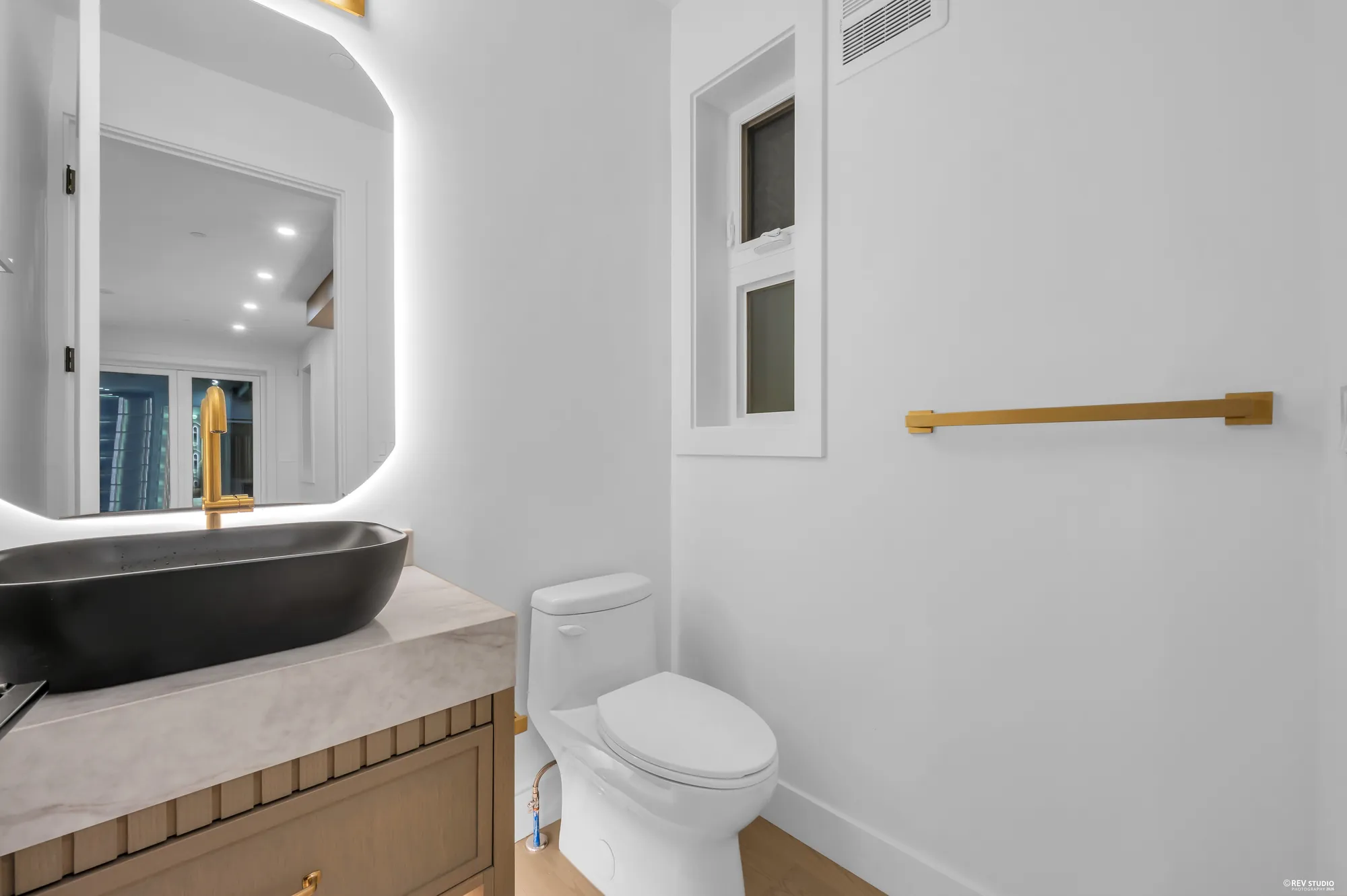 Powder room with a stone counter, vessel basin and slim window